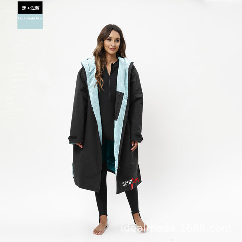 Woman wearing a black and light blue coat on a white background